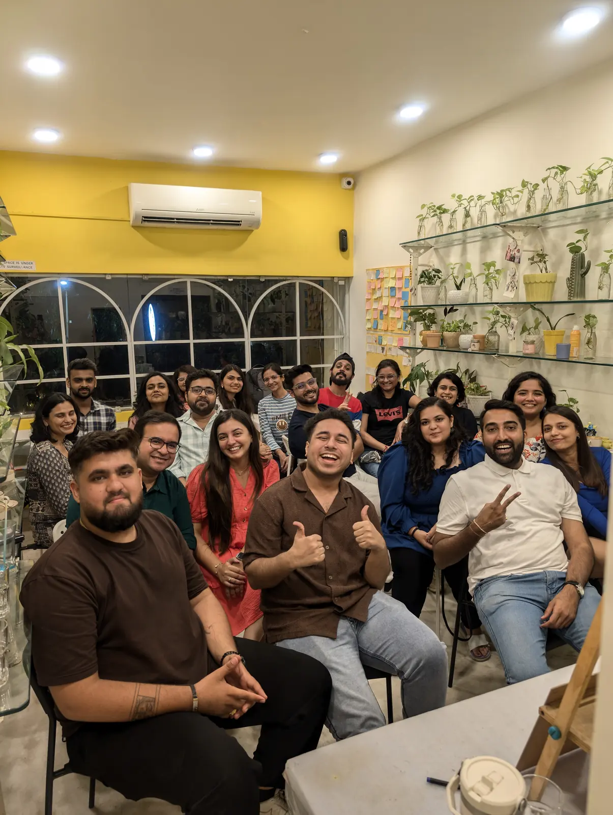 A full room of guests seated for an evening event against the yellow wall